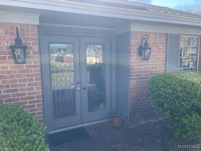 property entrance with french doors and brick siding