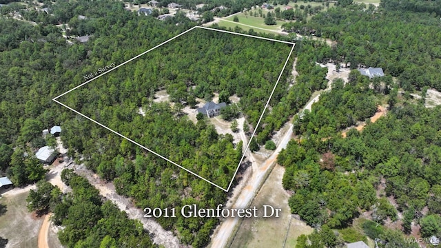 birds eye view of property featuring a view of trees