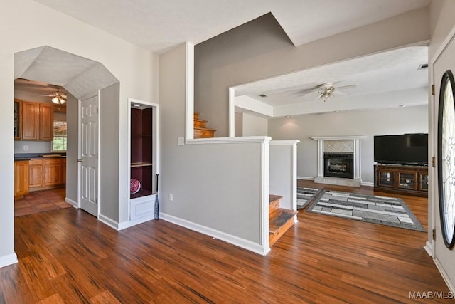 2011 Glenforest Dr, Prattville, AL 36067 - unfurnished living room with stairway, baseboards, a ceiling fan, and dark wood-style flooring