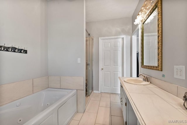 2011 Glenforest Dr, Prattville, AL 36067 - bathroom featuring tile patterned floors, a tub with jets, a shower stall, and vanity
