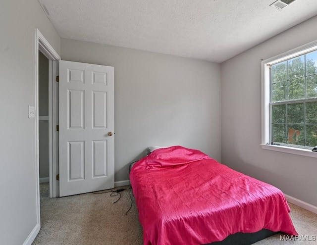2011 Glenforest Dr, Prattville, AL 36067 - bedroom with visible vents, a textured ceiling, baseboards, and carpet