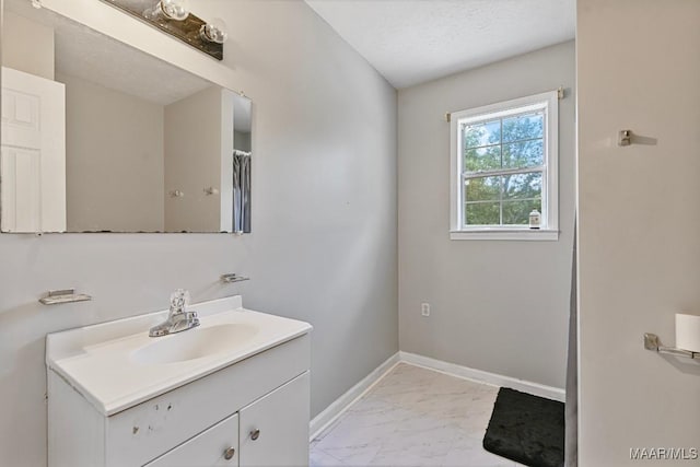 2011 Glenforest Dr, Prattville, AL 36067 - bathroom with baseboards, a textured ceiling, marble finish floor, and vanity