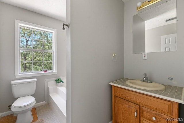 2011 Glenforest Dr, Prattville, AL 36067 - bathroom featuring a garden tub, baseboards, toilet, and vanity