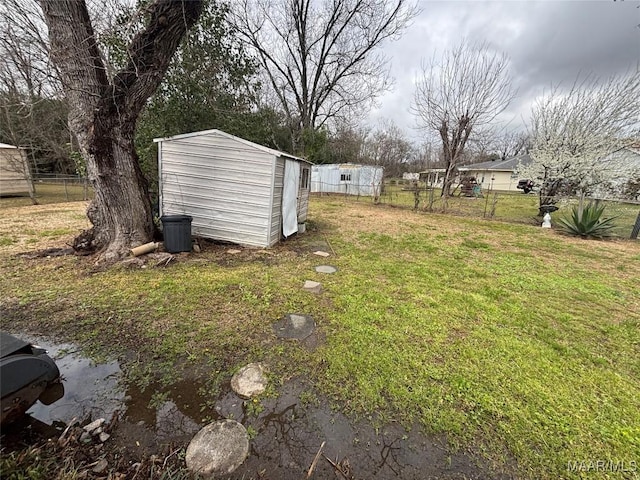 115 Kingswood Rd, Montgomery, AL 36108 - view of yard with an outdoor structure, fence, and a storage unit