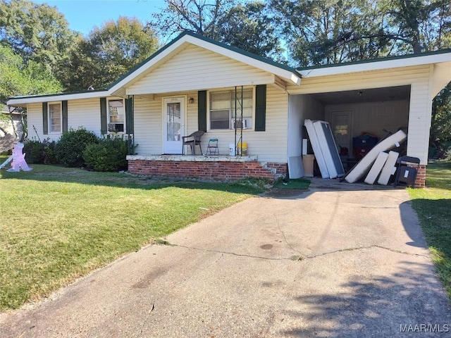view of front of house featuring an attached carport, a front yard, covered porch, and driveway