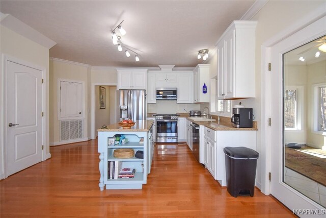 74 Lake Point Dr, Jacksons Gap, AL 36861 - kitchen with a sink, light wood-type flooring, white cabinetry, and stainless steel appliances