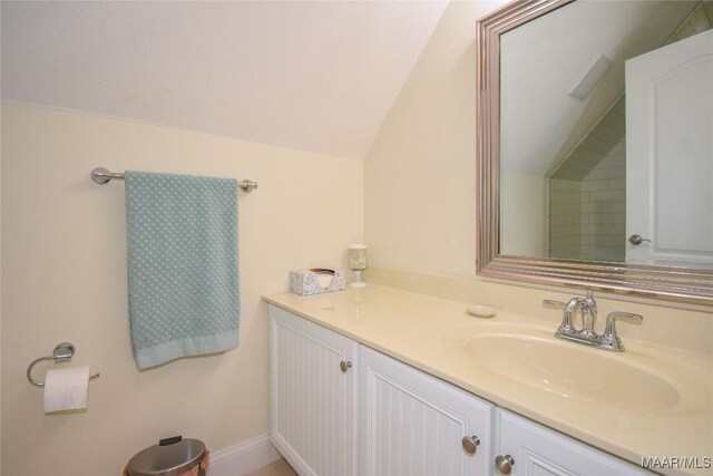 74 Lake Point Dr, Jacksons Gap, AL 36861 - bathroom with vanity, baseboards, and vaulted ceiling
