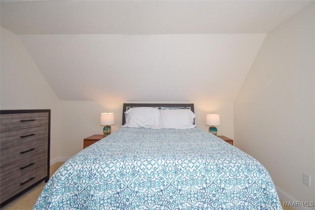 74 Lake Point Dr, Jacksons Gap, AL 36861 - bedroom featuring vaulted ceiling, light colored carpet, and baseboards
