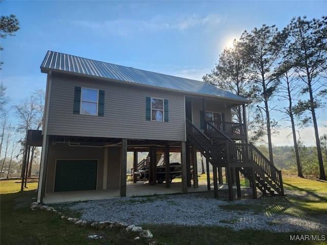 2085 Robinson Pond Rd, Prattville, AL 36067 - exterior space with metal roof, a carport, an attached garage, and stairway