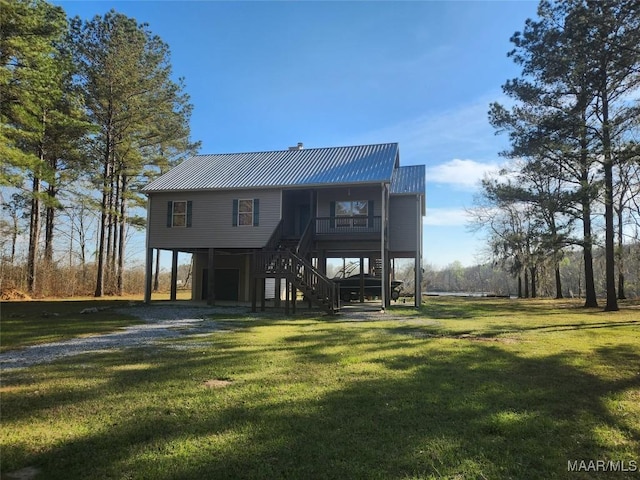 2085 Robinson Pond Rd, Prattville, AL 36067 - view of front of house featuring driveway, stairway, a front yard, metal roof, and a carport