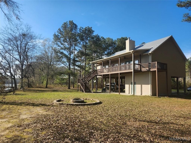 2085 Robinson Pond Rd, Prattville, AL 36067 - rear view of property featuring an outdoor fire pit, stairs, a lawn, a chimney, and a deck