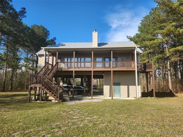 2085 Robinson Pond Rd, Prattville, AL 36067 - back of property with a lawn, a deck, stairs, metal roof, and a chimney