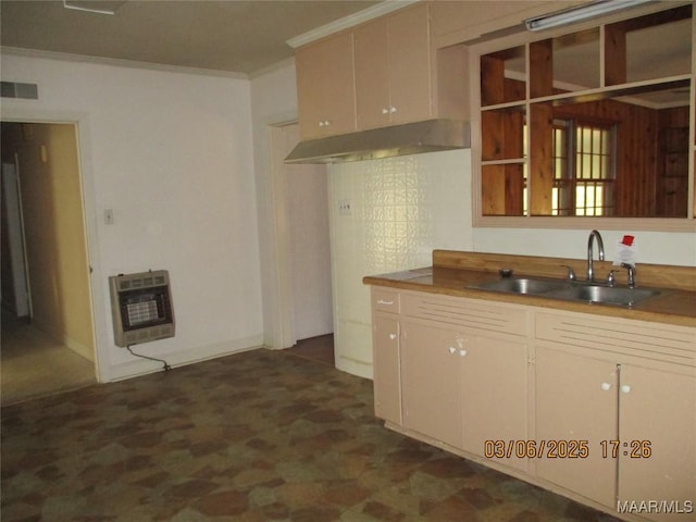 kitchen with heating unit, visible vents, a sink, under cabinet range hood, and crown molding