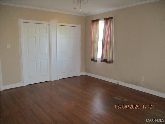 unfurnished bedroom with crown molding, baseboards, and wood finished floors