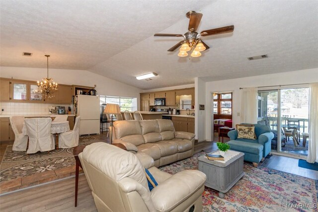 100 Royal Dr, Equality, AL 36026 - living room featuring lofted ceiling, ceiling fan with notable chandelier, visible vents, and light wood finished floors