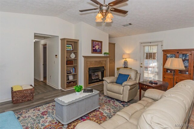 100 Royal Dr, Equality, AL 36026 - living area featuring visible vents, a ceiling fan, wood finished floors, a fireplace, and vaulted ceiling