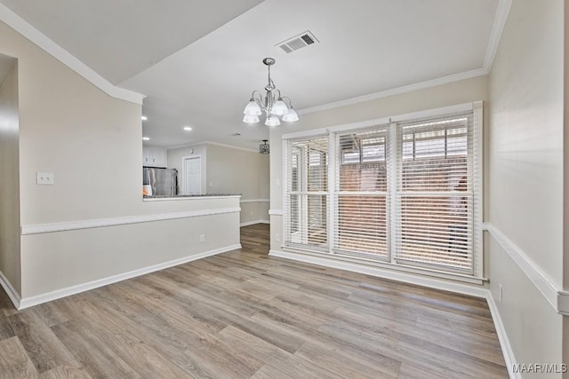 6528 Enfield Mews, Montgomery, AL 36117 - unfurnished dining area with visible vents, wood finished floors, crown molding, and a chandelier