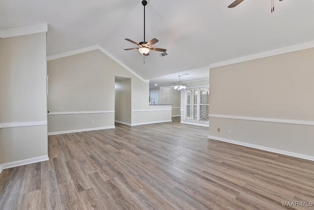 6528 Enfield Mews, Montgomery, AL 36117 - unfurnished living room with ceiling fan with notable chandelier, baseboards, lofted ceiling, and wood finished floors