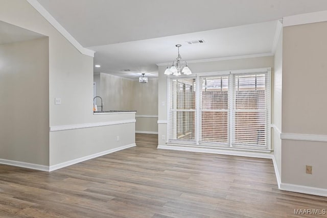 6528 Enfield Mews, Montgomery, AL 36117 - unfurnished dining area with visible vents, baseboards, a chandelier, ornamental molding, and wood finished floors