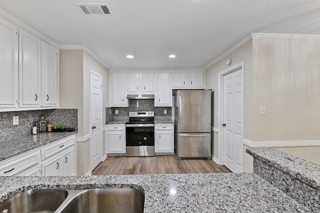 6528 Enfield Mews, Montgomery, AL 36117 - kitchen featuring light stone counters, visible vents, stainless steel appliances, white cabinets, and under cabinet range hood