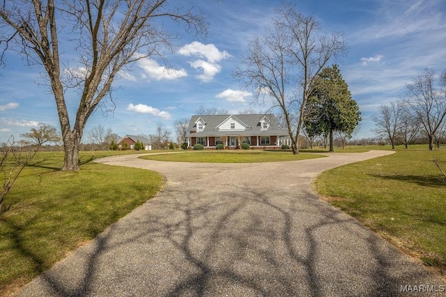 view of front of house featuring a front lawn, a porch, and curved driveway