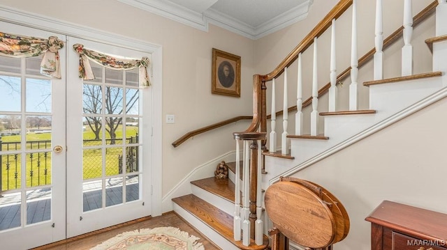 stairs featuring wood finished floors, baseboards, and ornamental molding