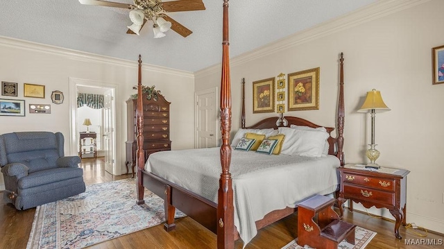 bedroom with wood finished floors, a textured ceiling, and ornamental molding