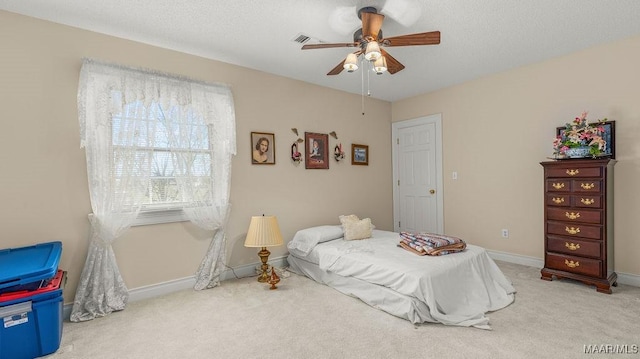 bedroom with carpet flooring, a textured ceiling, baseboards, and a ceiling fan