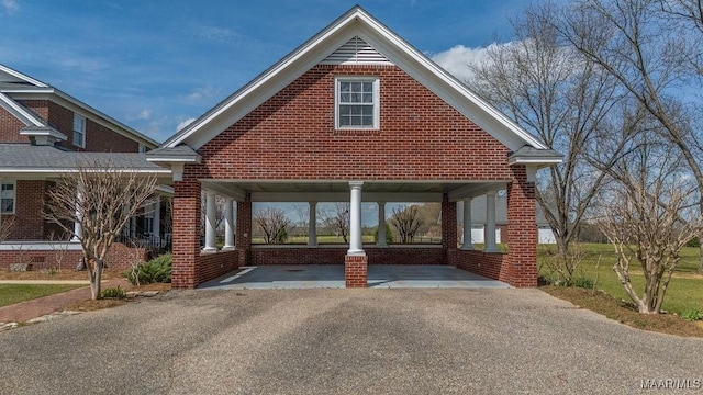 traditional-style home featuring brick siding and driveway