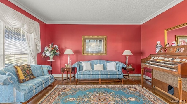 living room with baseboards, a textured ceiling, wood finished floors, and crown molding