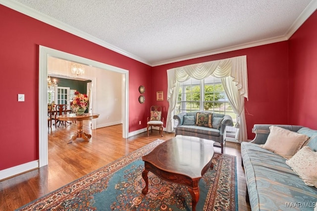 13650 County Road 29th Rd, Clanton, AL 35045 - living area featuring a textured ceiling, crown molding, wood finished floors, and a chandelier