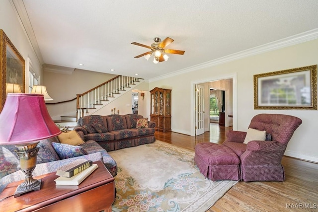 13650 County Road 29th Rd, Clanton, AL 35045 - living area with wood finished floors, crown molding, stairway, a ceiling fan, and french doors