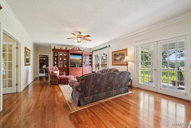 13650 County Road 29th Rd, Clanton, AL 35045 - living room featuring a textured ceiling, ornamental molding, french doors, wood finished floors, and a ceiling fan