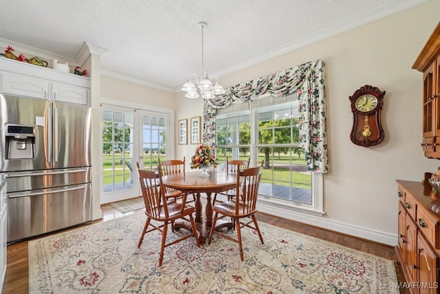 13650 County Road 29th Rd, Clanton, AL 35045 - dining area featuring crown molding, a textured ceiling, a chandelier, light wood-type flooring, and french doors