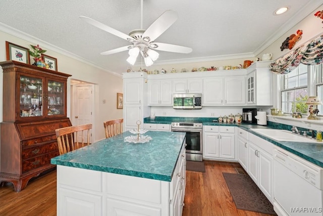 13650 County Road 29th Rd, Clanton, AL 35045 - kitchen featuring appliances with stainless steel finishes, crown molding, glass insert cabinets, dark wood finished floors, and dark countertops