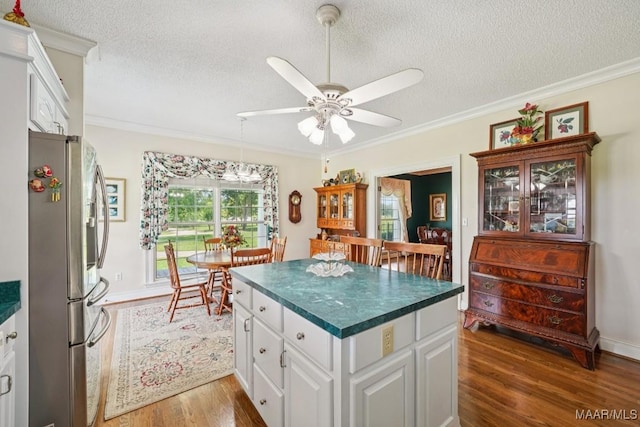 13650 County Road 29th Rd, Clanton, AL 35045 - kitchen with stainless steel refrigerator with ice dispenser, dark countertops, a textured ceiling, ceiling fan, and wood finished floors
