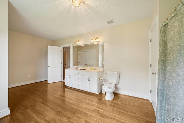 13650 County Road 29th Rd, Clanton, AL 35045 - bathroom featuring double vanity, wood finished floors, and a textured ceiling