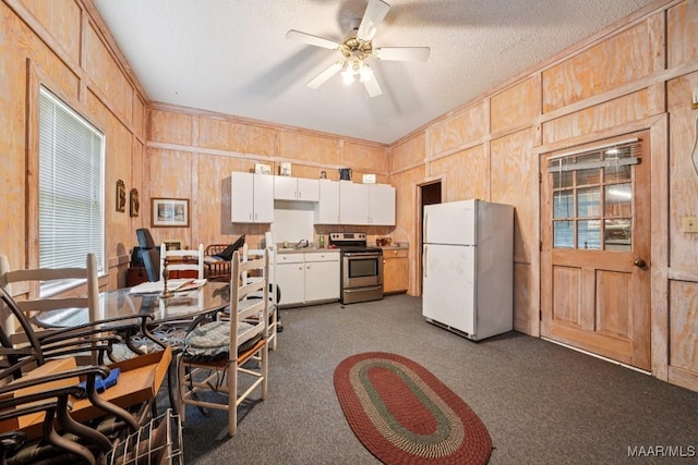 13650 County Road 29th Rd, Clanton, AL 35045 - kitchen with freestanding refrigerator, stainless steel range with electric stovetop, dark carpet, white cabinets, and ceiling fan