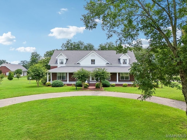 13650 County Road 29th Rd, Clanton, AL 35045 - view of front of house featuring curved driveway, a front yard, covered porch, and a shingled roof