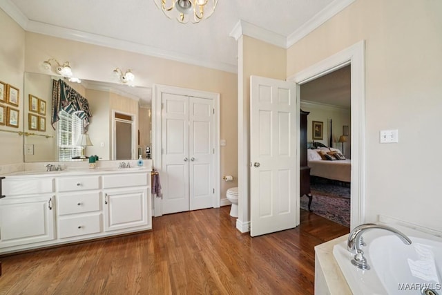 13650 County Road 29th Rd, Clanton, AL 35045 - full bathroom featuring ornamental molding, double vanity, a chandelier, wood finished floors, and a garden tub