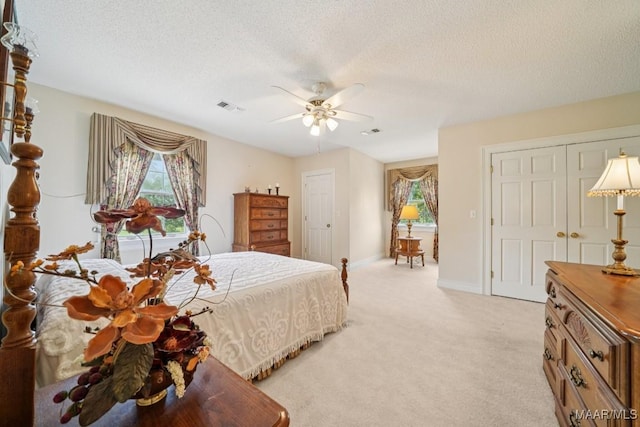 13650 County Road 29th Rd, Clanton, AL 35045 - bedroom featuring multiple windows, light colored carpet, a textured ceiling, and a ceiling fan