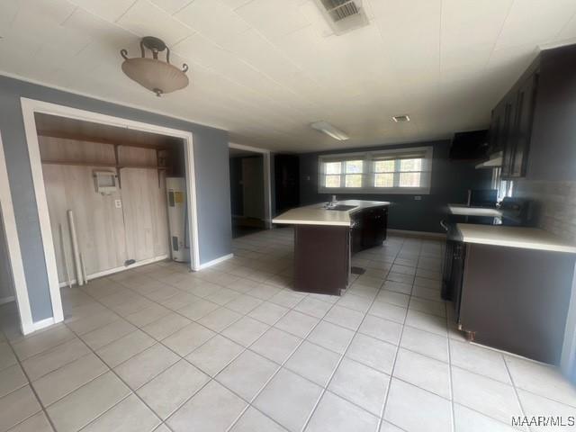 2343 Friendship Rd, Tallassee, AL 36078 - kitchen with baseboards, visible vents, light tile patterned flooring, a sink, and light countertops