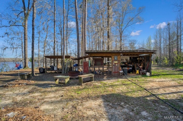 view of yard with an outbuilding, an attached carport, and a pole building