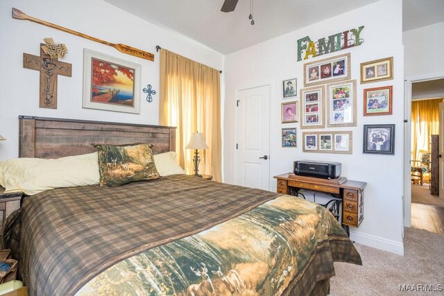 bedroom with a ceiling fan, carpet, and baseboards