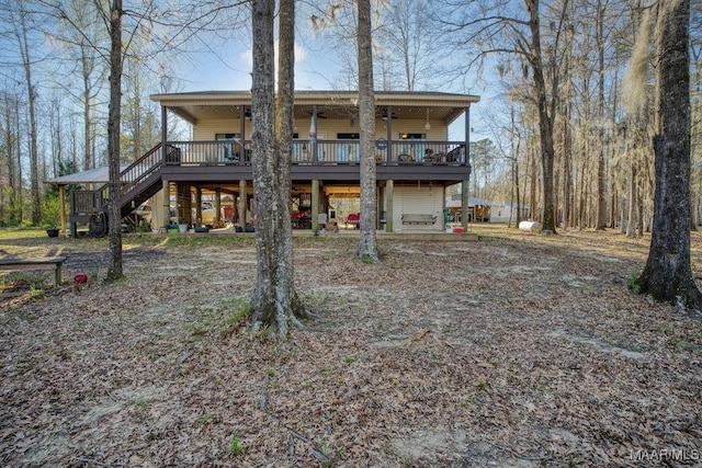 rear view of property featuring a wooden deck