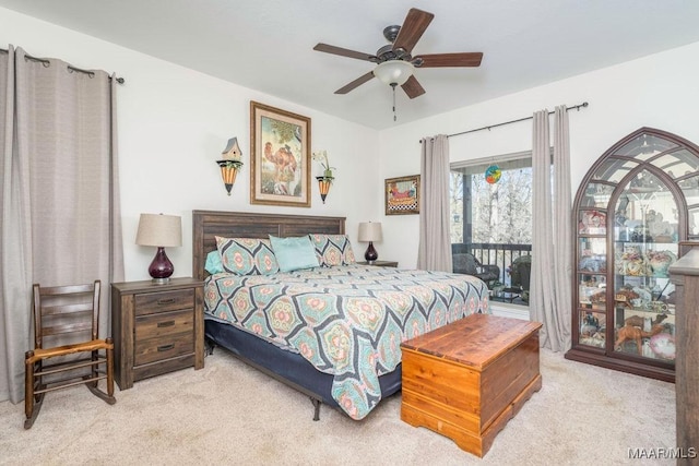 carpeted bedroom with a ceiling fan and access to outside
