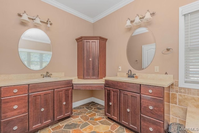 full bath with ornamental molding, two vanities, and a sink
