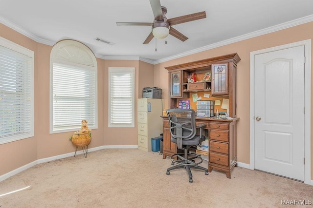 carpeted home office with crown molding, baseboards, visible vents, and ceiling fan