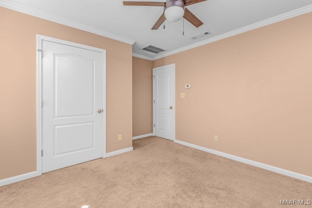 unfurnished bedroom with visible vents, light carpet, baseboards, and crown molding