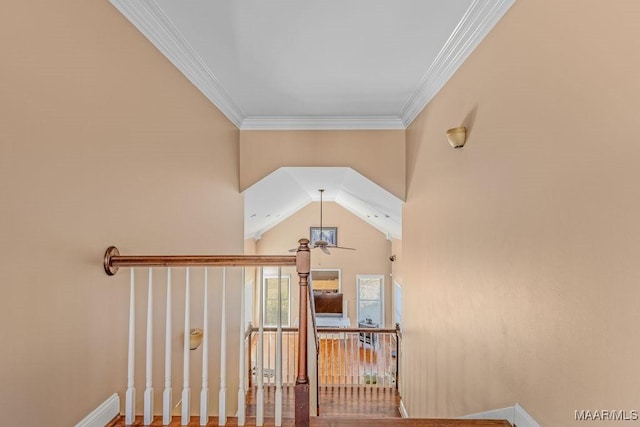 stairway with a ceiling fan and ornamental molding